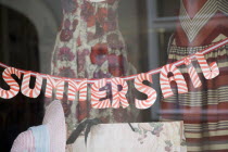 Austria, Vienna, Sale sign in dress shop window, spelt SAIL.