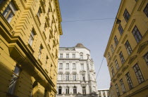 Austria, Vienna, White and yellow painted exterior facades of restored buildings.