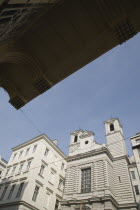 Austria, Vienna, Neubau District, Church exterior viewed from beneath awning of apartment building opposite.