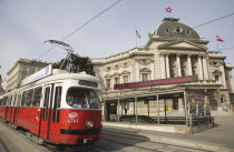 Austria, Vienna, Neubau District, Early model Wiener Linien Tram outside The Volkstheater with digital ticker sign displaying information above entrance to metro station behind.