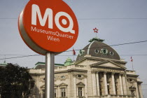 Austria, Vienna, Neubau District, Circular information sign with MQ in white on orange to indicate the Museums Quartier or Museums Quarter outside The Volkstheater.