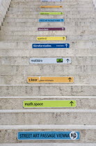 Austria, Vienna, Neubau District, Coloured signs giving directions on the steps of the Museum of Modern Art, Museum Moderner Kunst Stiftung Ludwig Wien or MUMOK in the MuseumsQuartier or Museums Quart...