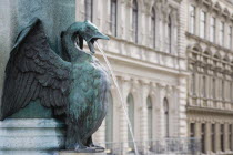 Austria, Vienna, Neubau District, Detail of bronze fountain depicting goose or swan with outstretched wings spouting water from open beak.