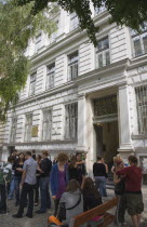 Austria, Vienna, Neubau District, Students gathered outside college building entrance.