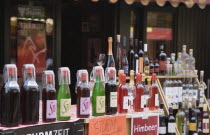 Austria, Vienna, The Naschmarkt, Display of Federweisser, wine in the fermentation stage, known as Sturm in Austria, line of bottles with tasting glasses. Due to the carbonic acid, Federweier tas...