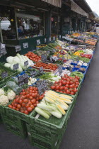 Austria, Vienna, The Naschmarkt, display of fresh fruit and vegetables in front of shopfronts.