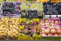 Austria, Vienna, The Naschmarkt, Display of fresh fruit for sale including apricots, grapes and mangoes.