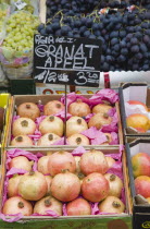Austria, Vienna, The Naschmarkt, Display of fresh fruit for sale on market stall with grapes and pomegranates.