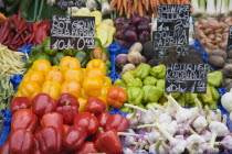 Austria, Vienna, The Naschmarkt, Fresh produce stall with display including chillies, peppers, garlic, onions, shallots and turnips. 