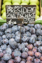 Austria, Vienna, The Naschmarkt, Fresh plums for sale on market fruit stall display.