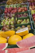 Austria, Vienna, The Naschmarkt, Market fruit stall with display of melon and apples.