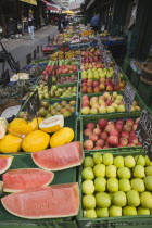 Austria, Vienna, The Naschmarkt, Display of melon and apples for sale on fresh fruit stall in market.