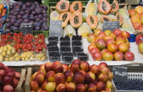 Austria, Vienna, Display of fresh fruit for sale on market stall including plums, strawberries, papaya, mango and nectarines. 