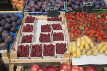 Austria, Vienna, Display of fresh fruit for sale on market stall including figs, raspberries, strawberries, plums and bananas. 