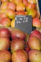 Austria, Vienna, Mangoes for sale on market stall.