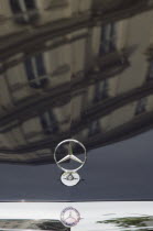 Austria, Vienna, Building facade reflected in bonnet of Mercedes car.  