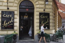 Austria, Vienna, Mariahilf District, Cafe Sperl, the preferred cafe of Adolf Hitler. Exterior facade with waitress carrying coffee order out to customers at outside tables beneath striped awning. ...