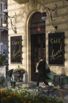 Austria, Vienna, Mariahilf District, Cafe Sperl, the preferred cafe of Adolf Hitler. Exterior with empty outside tables and woman passing entrance carrying bags.  Established for over 120 years, t...