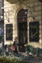 Austria, Vienna, Mariahilf District, Cafe Sperl, the preferred cafe of Adolf Hitler. Exterior with empty outside tables and woman walking past entrance. Established for  over 120 years, the cafe offer...
