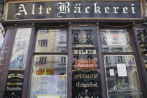 Austria, Vienna, Part view of exterior facade of restaurant with traditional signage.   