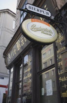 Austria, Vienna, Angled view of pub facade with hanging  beer signs.  