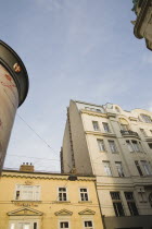 Austria, Vienna, Building exterior facades with partly seen  advertising column in foreground.  