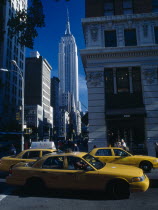 USA, New York, Manhattan, View along 5th Avenue toward the Empire State Building with yellow cabs in the foreground.