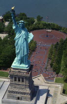 USA, New York, Liberty Island, Aerial view of the Statue of Liberty, with crowds of tourists queuing to enter.