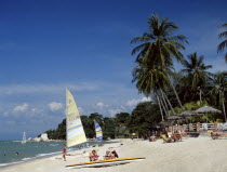 Malaysia, Penang, Batu Ferringhi, Beach scene with tourists sunbathing.