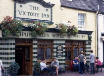 England, East Sussex, Brighton, tourists sat outside the Victory Inn public house.