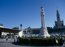 Portugal, Beira Litoral, Fatima, Golden Statue of Christ with church in the background.