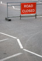 Transport, Road, Signs, Red Road Closed Traffic sign on barrier across empty urban road in Bognor Regis.