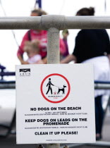 England, West Sussex, Bognor Regis, Sign on seafront railings warning that no dogs are allowed on the beach, must wear leads on the promenade and must be cleaned up afterwards.