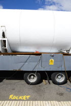 England, West Sussex, Bognor Regis, Funfair ride the Rocket parked on trailer on the Esplanade with the word Rocket written in yellow spray paint on the road beside it. Danger Of Elecrocution hazard w...