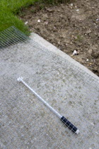 Climate, Weather, Measurements, Thermometer beneath protective wire mesh laid on concrete to measure the minimum overnight concrete temperature beside patch of clear earth where the moisture content o...