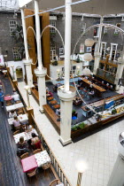 Ireland, County Dublin, Dublin City, Powerscourt Centre restaurants with people at tables beside shops in the enclosed old Georgian townhouse courtyard.