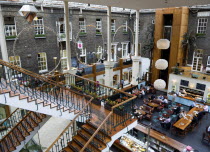 Ireland, County Dublin, Dublin City, Powerscourt Centre restaurants with people at tables beside shops in the enclosed old Georgian townhouse courtyard.