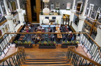 Ireland, County Dublin, Dublin City, Powerscourt Centre restaurants with people at tables beside shops in the enclosed old Georgian townhouse courtyard.