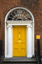 Ireland, County Dublin, Dublin City, Yellow Georgian door in the city centre south of the Liffey River.