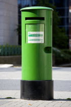 Ireland, County Dublin, Dublin City, A traditional old fashioned green letterbox on the pavement sidewalk.