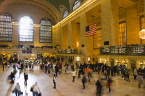 USA, New York, Manhattan, Grand Central Terminal railway station with people walking in the Main Concourse and passengers buying tickets.