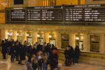 USA, New York, Manhattan, Grand Central Terminal railway station with people buying tickets from ticketing booths in the Main Concourse.