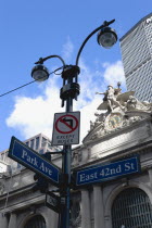 USA, New York, Manhattan, Sculpture by Jules-Alexis Coutans of Mercury, Hercules and Minerva on the 42nd Street facade of Grand Central Terminal railway station and a streetlight with road signs for P...