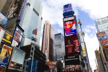USA, New York, Manhattan, Times Square at the junction of 7th Avenue and Broadway below buildings with advertising on large video screens.