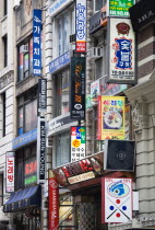 USA, New York, Manhattan, Korean signs for restaurants and shops on buildings in Little Korea on West 32nd Street in midtown.