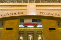 USA, New York, Manhattan, Grand Central Terminal railway station entrance to the Main Concourse from the Vanderbilt Hall with the American Stars and Stripes flag hanging from the ceiling.