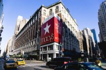 USA, New York, Manhattan, Macys department store with cars on 34th Street and people walking in the pedestrianised Broadway. **Editorial Use Only**