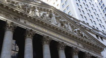 USA, New York, Manhattan, The New York Stock Exchange building in Broad Street beside Wall Street showing the main facade of the building featuring marble sculpture by John Quincy Adams Ward in the pe...