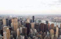 USA, New York, Manhattan, View from Empire State building over midtown skyscrapers and East River towards Queens and Long Island.