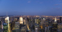 USA, New York, Manhattan, View from Empire State building over midtown skyscrapers with Art Deco Chrysler Building illuminated at sunset.